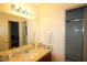 Bathroom featuring a vanity, mirror and access to walk-in shower at 502 W Poplar Ave # C2, Carrboro, NC 27510