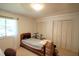 Bedroom with a twin bed, window with blinds, and closet with louvered doors at 502 W Poplar Ave # C2, Carrboro, NC 27510