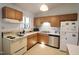 Functional kitchen with tile floor, stainless steel appliances and wood cabinets at 502 W Poplar Ave # C2, Carrboro, NC 27510