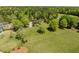 Expansive property features a lush green lawn, mature trees, and fenced-in perimeter at 5212 Theys Rd, Raleigh, NC 27606