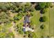 Aerial view of a home and detached garage surrounded by a circular driveway and landscaping at 5212 Theys Rd, Raleigh, NC 27606