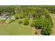 A lush green lawn surrounds homes situated between a forest and open field at 5212 Theys Rd, Raleigh, NC 27606
