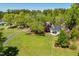 Charming home boasts a sprawling lawn, mature trees, and a serene, private setting at 5212 Theys Rd, Raleigh, NC 27606