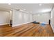 Spacious basement with wood flooring, a wet bar area, and a workout space at 5212 Theys Rd, Raleigh, NC 27606