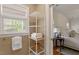 Bright bathroom with ample linen storage and views to a serene landscape at 5212 Theys Rd, Raleigh, NC 27606