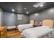 Cozy bedroom featuring two beds, hardwood floors, and moody, dark walls at 5212 Theys Rd, Raleigh, NC 27606