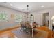 Inviting dining room with hardwood floors, gray furnishings, and natural light at 5212 Theys Rd, Raleigh, NC 27606