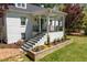 Inviting front entrance with beautiful landscaping and classic architectural details at 5212 Theys Rd, Raleigh, NC 27606