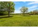 Sprawling front yard with mature trees and lush green grass, offering privacy at 5212 Theys Rd, Raleigh, NC 27606