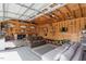 Finished garage space with paneled walls, sectional sofa, and tv at 5212 Theys Rd, Raleigh, NC 27606