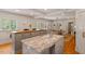 Bright kitchen with a center island, granite counters, and stainless steel faucet at 5212 Theys Rd, Raleigh, NC 27606