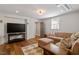 Relaxing living room showcases wood floors, a large TV, and comfortable seating area at 5212 Theys Rd, Raleigh, NC 27606