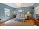 Comfortable living room with blue walls, natural light, and stylish furnishings at 5212 Theys Rd, Raleigh, NC 27606