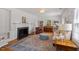 Elegant living room with fireplace, built-in bookcases, and hardwood floors at 5212 Theys Rd, Raleigh, NC 27606