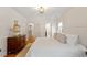 Serene main bedroom with hardwood floors, white walls, and ample natural light at 5212 Theys Rd, Raleigh, NC 27606