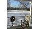 Charming porch view with a rocking chair, wreath and snowy pasture landscape at 5212 Theys Rd, Raleigh, NC 27606