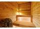 Beautiful home sauna with wooden bench seating, lighting, and lava rocks at 5212 Theys Rd, Raleigh, NC 27606