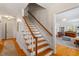Classic staircase with hardwood treads and white risers, leading to the upper level at 5212 Theys Rd, Raleigh, NC 27606