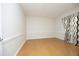 Inviting bedroom with neutral walls, cork floor, and a window with stylish patterned curtains at 5403 Bayside Ct, Raleigh, NC 27613