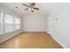 Spacious bedroom with ceiling fan, a large window, and ample natural light at 5403 Bayside Ct, Raleigh, NC 27613