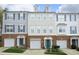 Row of townhomes showing brick facades, garage doors, and colorful front doors in a residential neighborhood at 5403 Bayside Ct, Raleigh, NC 27613