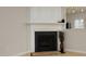 Close-up of fireplace with white mantel, dark stone surround, and decorative accents adding warmth to the room at 5403 Bayside Ct, Raleigh, NC 27613