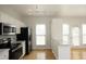 Bright kitchen area featuring stainless steel appliances and adjacent breakfast bar at 5403 Bayside Ct, Raleigh, NC 27613