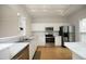 Bright kitchen with stainless steel appliances, marble countertops, and ample cabinet space at 5403 Bayside Ct, Raleigh, NC 27613