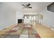 Spacious living room with hardwood floors, a fireplace, and ample natural light from the back windows at 5403 Bayside Ct, Raleigh, NC 27613