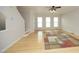 Bright living room with light wood floors, neutral walls, and a large window for ample natural light at 5403 Bayside Ct, Raleigh, NC 27613