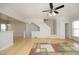 Open living area with light wood floors, access to the stairs, and a view of the connecting rooms at 5403 Bayside Ct, Raleigh, NC 27613