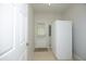 Functional mud room with tile floors, a back door, and a refrigerator for added convenience at 5403 Bayside Ct, Raleigh, NC 27613
