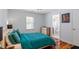 Cozy bedroom featuring hardwood floors, a comfortable bed, and ample natural light at 545 E Lenoir St, Raleigh, NC 27601