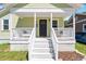 Charming home with a covered front porch and white railing leading to the front door at 545 E Lenoir St, Raleigh, NC 27601