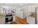 Open concept kitchen with stainless steel appliances and breakfast bar seating at 545 E Lenoir St, Raleigh, NC 27601