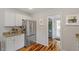 Modern kitchen with stainless steel refrigerator and access to the pantry at 545 E Lenoir St, Raleigh, NC 27601