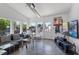 Bright living room with modern decor, large windows, and an outside view of the backyard and pool at 545 E Lenoir St, Raleigh, NC 27601
