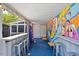 Outdoor patio with bar and lounge space featuring a colorful outdoor mural at 545 E Lenoir St, Raleigh, NC 27601