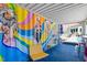 Fun outdoor patio features a vibrant mural, bar seating, and views of the backyard at 545 E Lenoir St, Raleigh, NC 27601