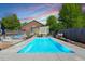 Beautiful backyard featuring a rectangular swimming pool, lounge chairs, and lush greenery at 545 E Lenoir St, Raleigh, NC 27601