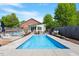 Backyard featuring a modern in-ground pool with an adjacent pool house and landscaped area at 545 E Lenoir St, Raleigh, NC 27601