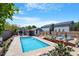Spacious backyard oasis with a sparkling pool, lush landscaping, and comfortable seating areas at 545 E Lenoir St, Raleigh, NC 27601