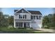 Charming two-story home with gray siding, black shutters, landscaped yard, and a two-car garage at 60 Glencoe Ln, Zebulon, NC 27597