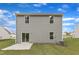 View of the home's backyard featuring a grassy lawn and concrete patio at 601 Benton Dr, Oxford, NC 27565