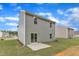 View of the home's backyard featuring a grassy lawn and concrete patio at 601 Benton Dr, Oxford, NC 27565