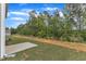 View of the backyard featuring a grassy lawn and green trees at 601 Benton Dr, Oxford, NC 27565