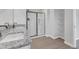 Bright bathroom with double sinks, granite countertops, walk-in shower with modern fixtures, and built-in shelving at 601 Benton Dr, Oxford, NC 27565