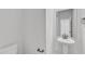 Half bathroom with pedestal sink, dark hardware, and mirror at 601 Benton Dr, Oxford, NC 27565