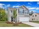 Attractive two-story home featuring a two-car garage, stylish siding, and a neatly landscaped front yard at 601 Benton Dr, Oxford, NC 27565
