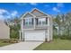 Stylish two-story home with gray siding, a two-car garage, and professionally landscaped front yard at 601 Benton Dr, Oxford, NC 27565